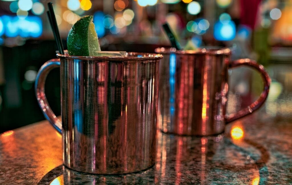 Closeup of two copper cups with cocktails