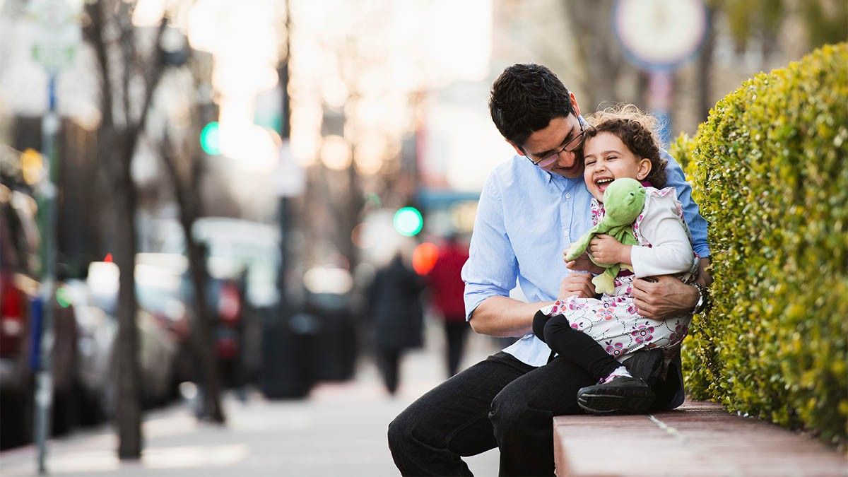 Father with daughter in city