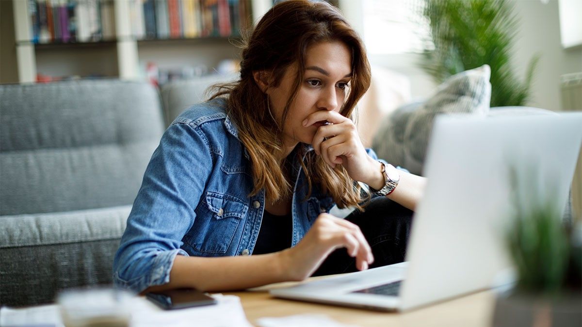 Woman on her laptop concerned over finances