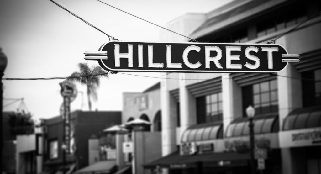 Black and white photo of retro neon sign reading Hillcrest. Hillcrest neighborhood San Diego.
