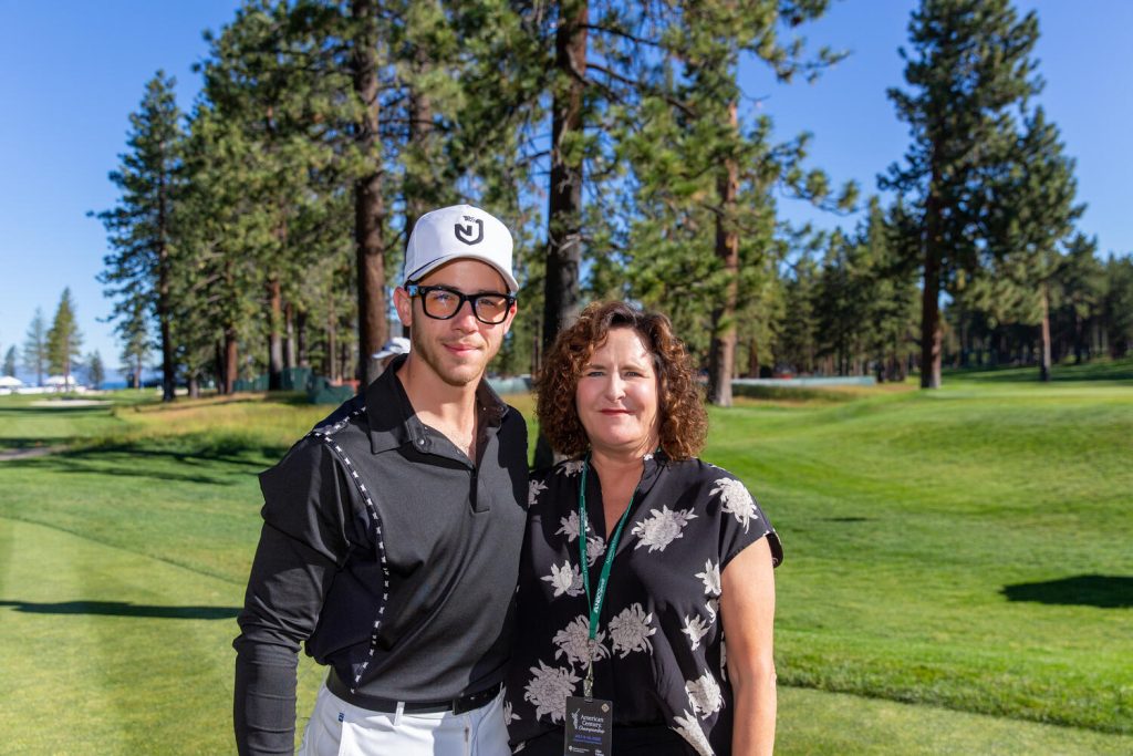 Engel & Völkers real estate advisor with Nick Jonas on the fairway at a celebrity golf event in Lake Tahoe.