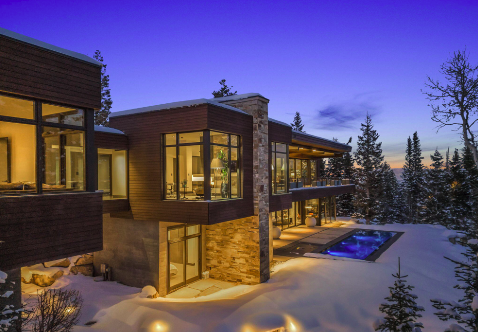 A geometric ski home that is dusted with snow.