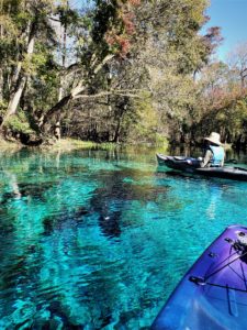 Man on kayak in blue spring