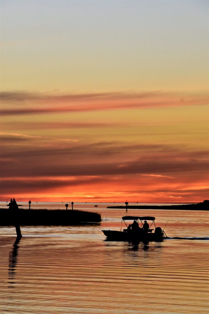 motor boat headed towatd dock at sunset on the Steinhatchee River