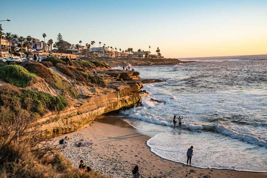Small beach with cliffs during sunset time.