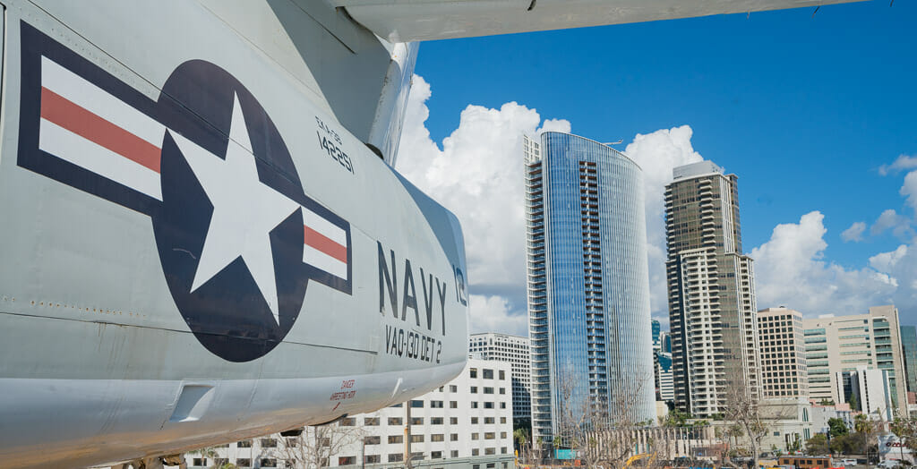 Historic Navy Aircraft on the USS Midway Aircraft carrier with the San Diego skyline in the background - San Diego Military bases