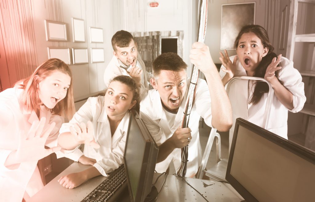 Guys and girls having fun in escape room stylized under abandoned lab