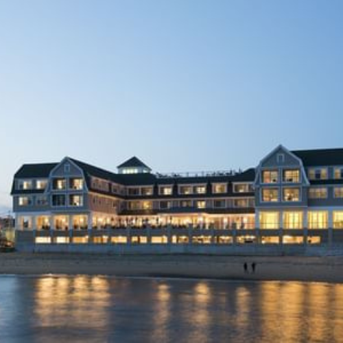 exterior of a luxury waterfront hotel at dusk