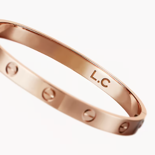 Rose gold bracelet with initial engraving on it.