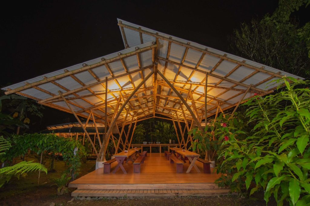 Outdoor, al-fresco dining room in the Costa Rican jungle with picnic tables and a canopy roof.