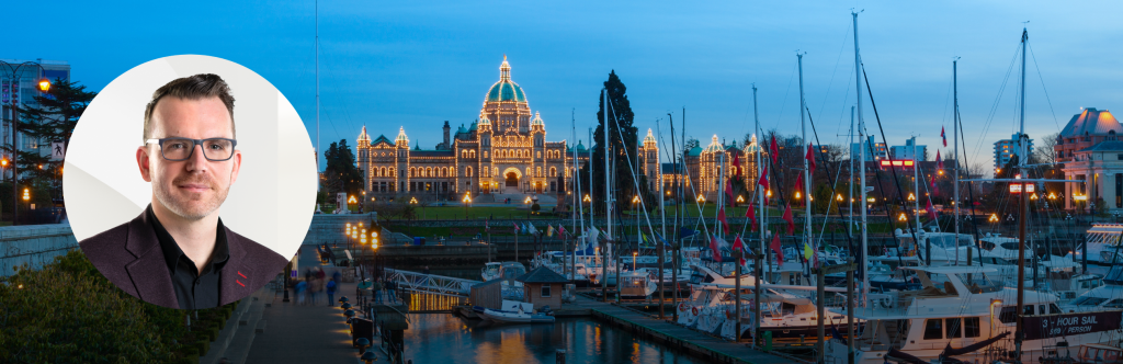 Headshot of Chris Margetts over a dusk picture of a harbor and official building in Victoria, British Columbia. 