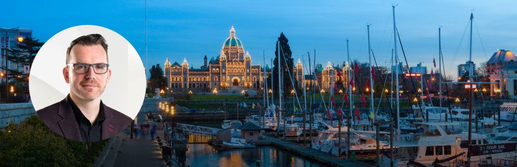 Headshot of Chris Margetts over a dusk picture of a harbor and official building in Victoria, British Columbia.