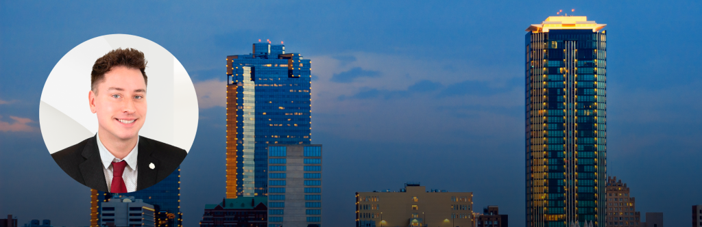 Headshot of Dan Nicoloff over a dusk picture of the Dallas Fort Worth skyline. 