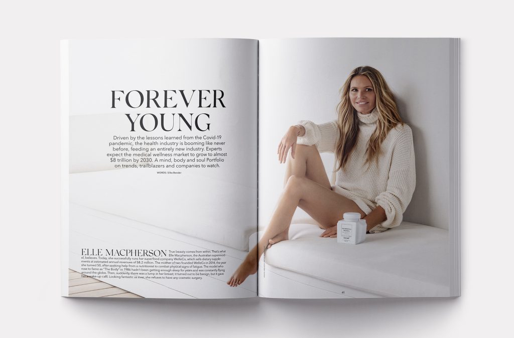 Interior spread of GG Magazine featuring Model Elle Macpherson sitting on a white couch in a white turtleneck sweater.