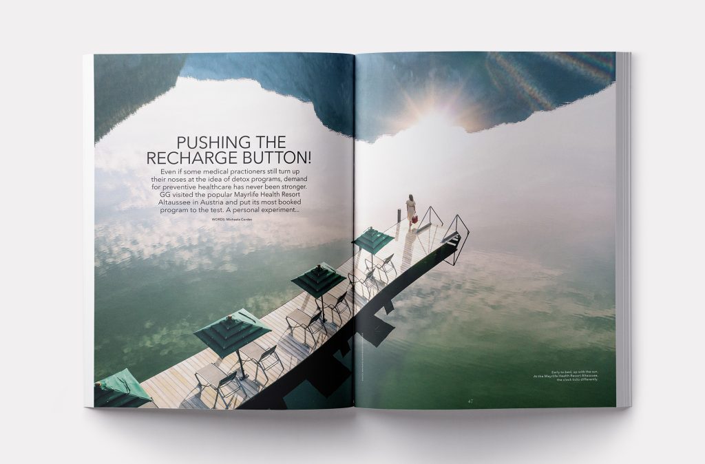 interior spread of the latest of GG Magazine, featuring a dock in a lake reflecting the Swiss mountains and a rising sun