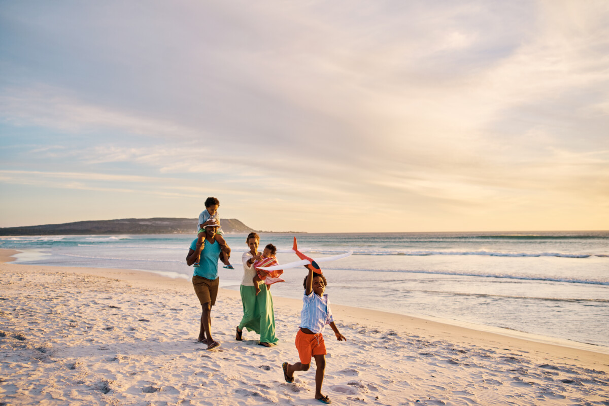 Family walking on the beach together on the weekend