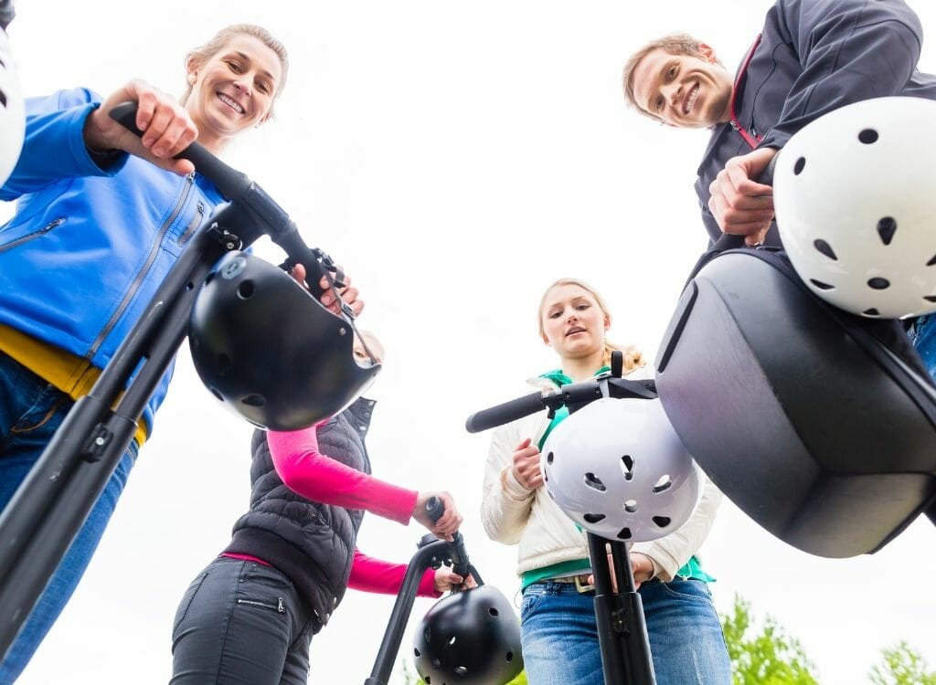 People on Segways parked in a circle looking down into the camera below