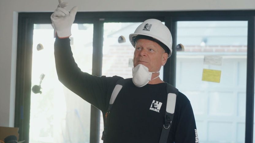 Mike Holmes points out a problem in a home he's come to fix on Season 2 of "Holmes Family Rescue."