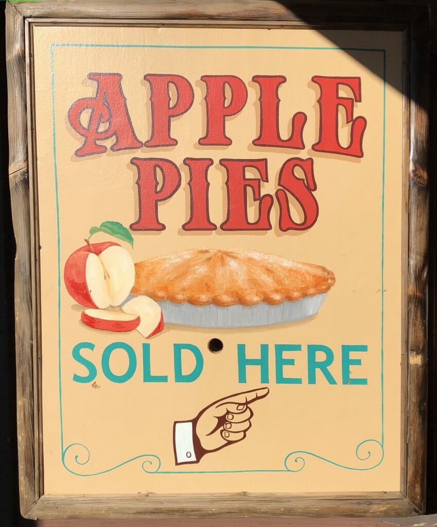 Historic sign in orange and red reading: Apple Pies sold here 