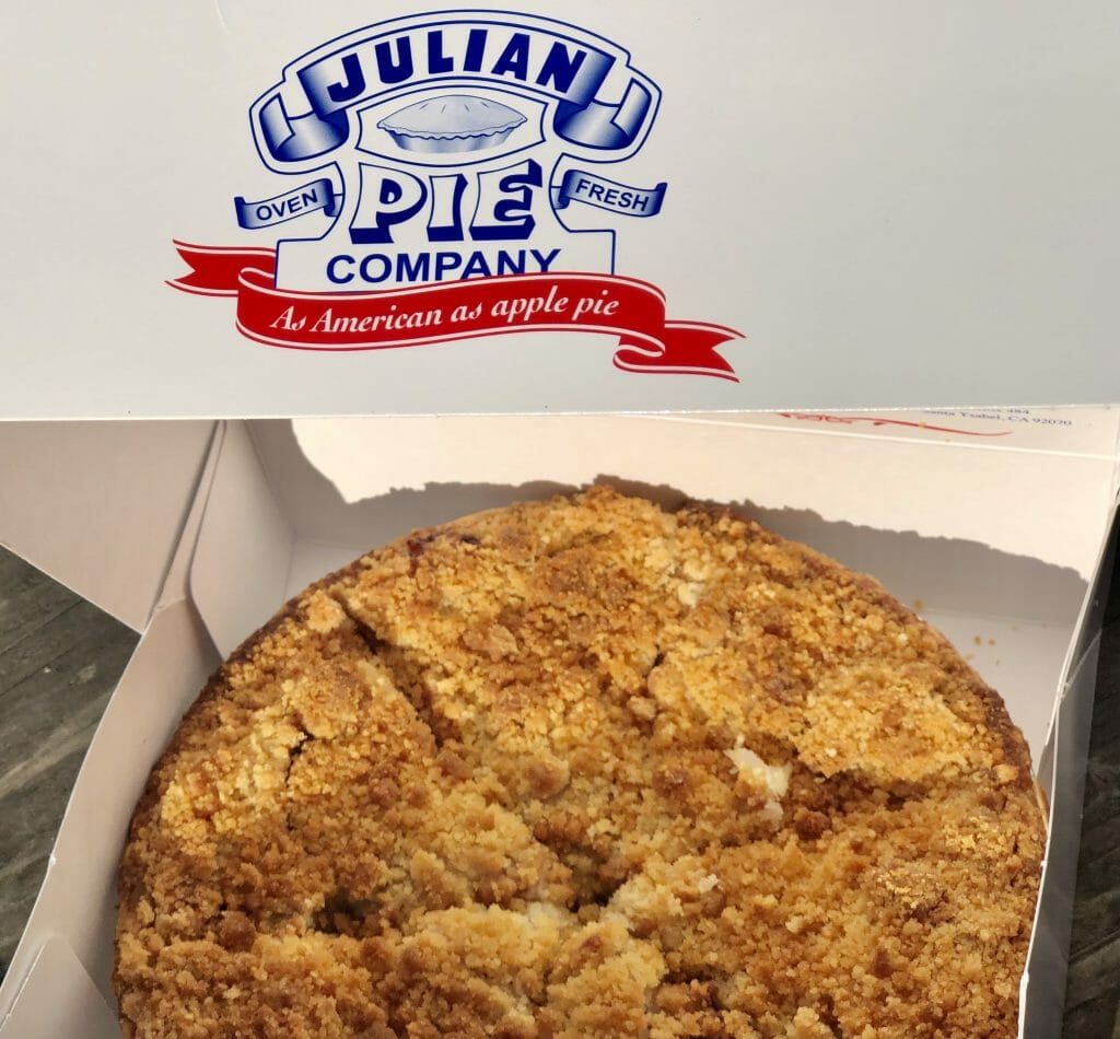 Whole Apple Crumble pie in a white box with writing: Julian Pie Company