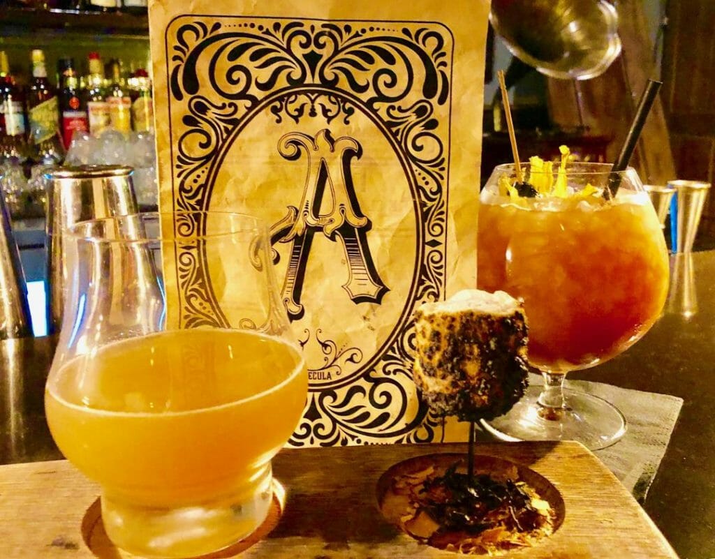 2 craft cocktails in a speakeasy in Temecula - with a menu with a vintage font letter A - things to do in Tememcula