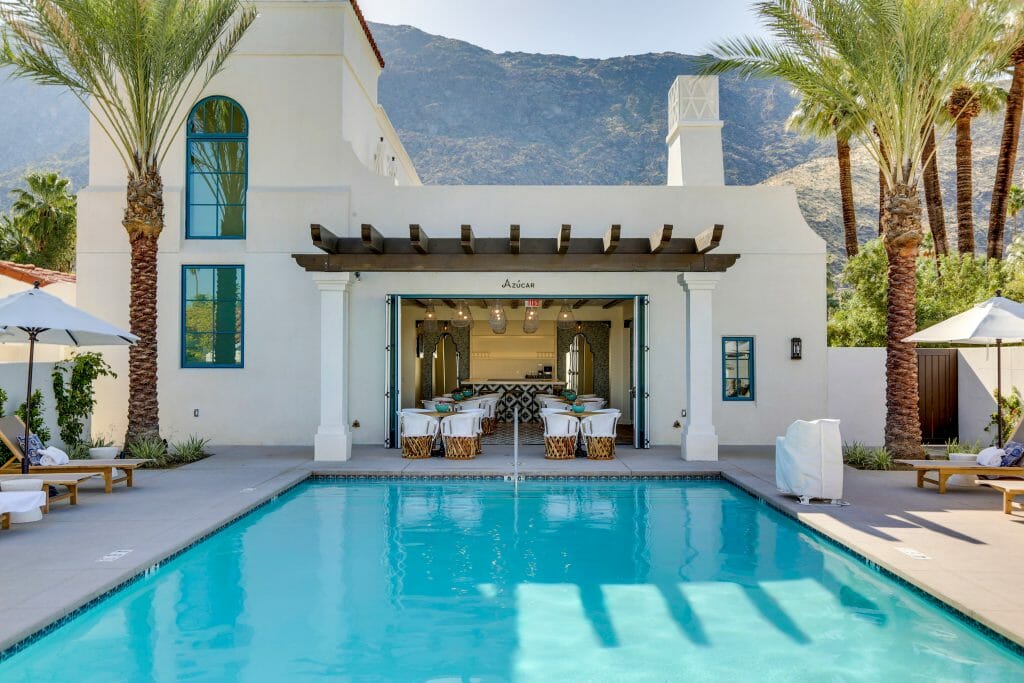 Pool in the foreground - Mexican style white building in the background