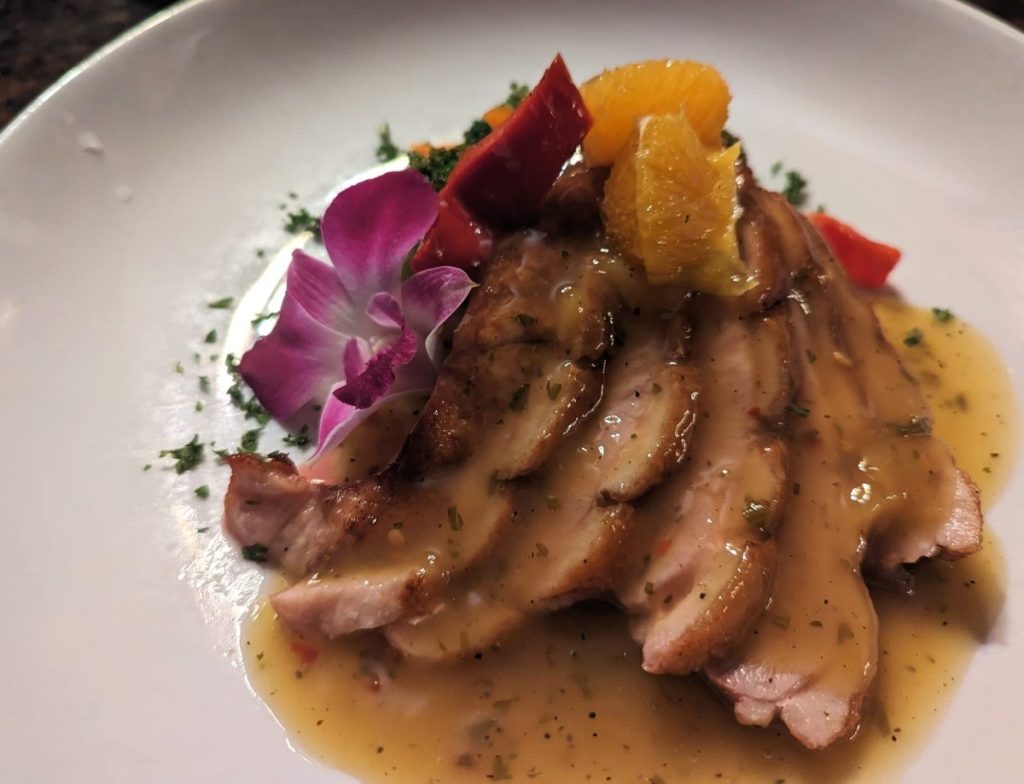 Duck a l'orange decorated with orchid and orange filets