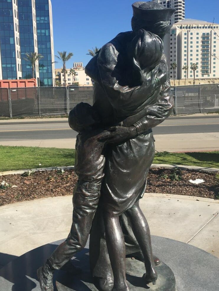 Metal statue of a soldier hugging his wife and child after returning from service - Statue is called "Homecoming" and is part of the "Greatest Generation Walk" Military Memorial in San Diego 