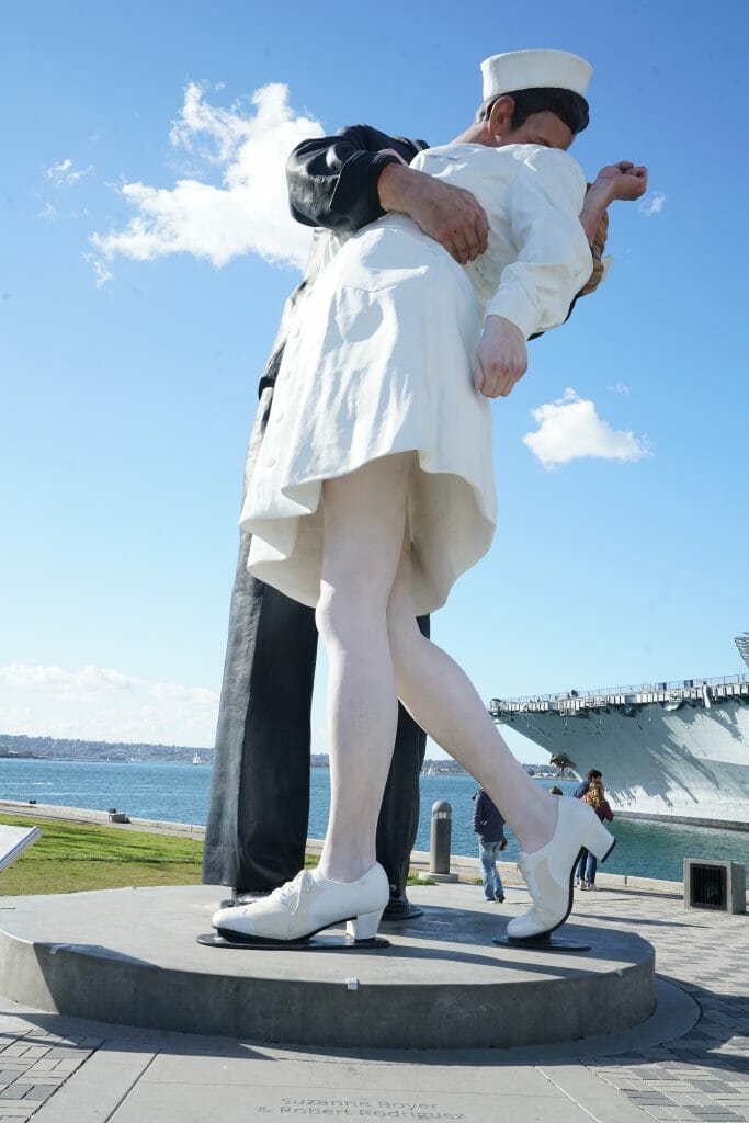 Famous statue of soldier kissing nurse in white nurse uniform based on famous photo of a real life scene on Times Square after the surrender of Japan and the end of World War II