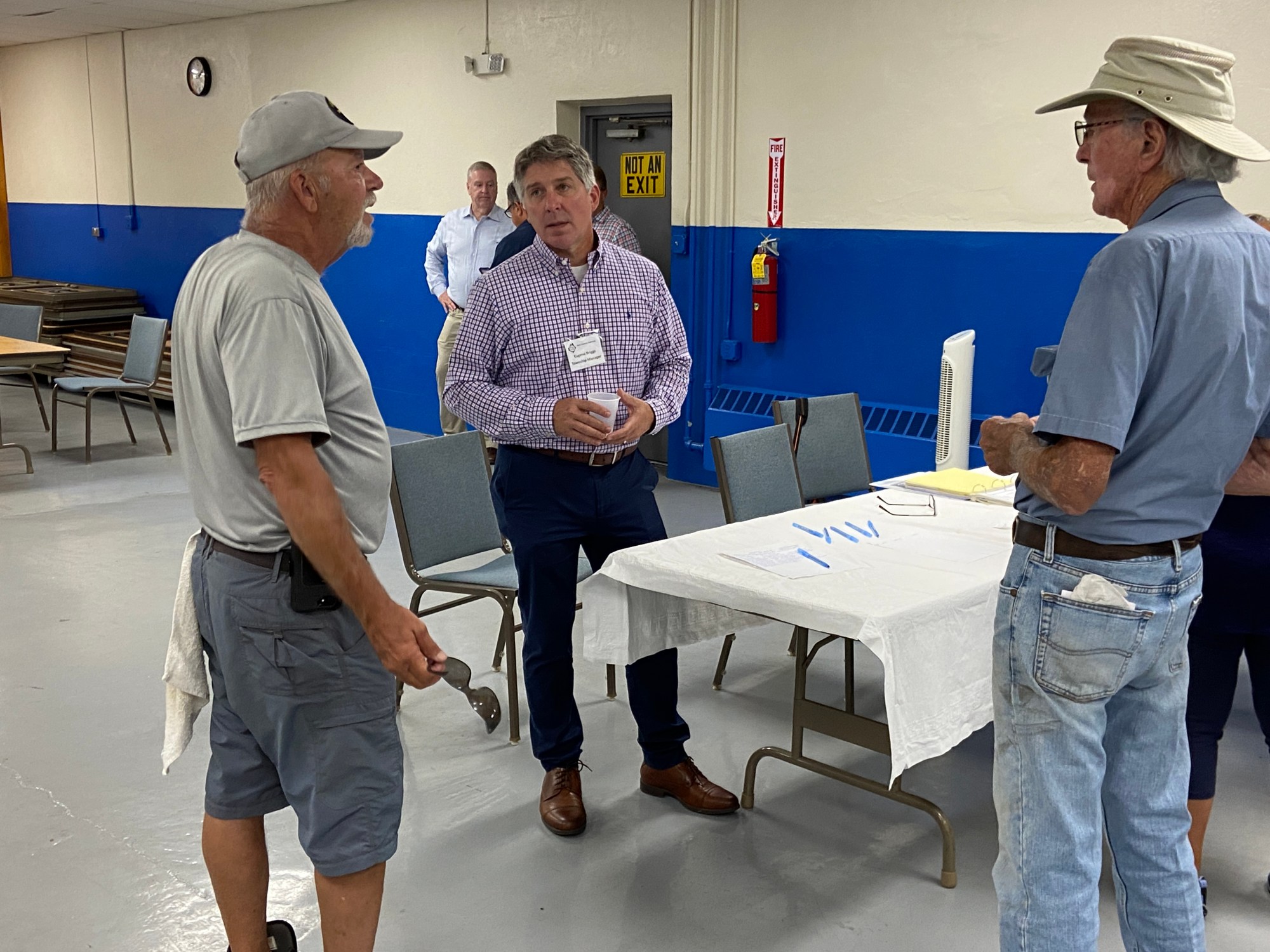 East Coventry Township Manager Eugene Briggs, center, talks with residents during the afternoon information session at Ridge Fire Company concerning the potential sale of the township's sewer collection system. (Evan Brandt -- MediaNews Group)