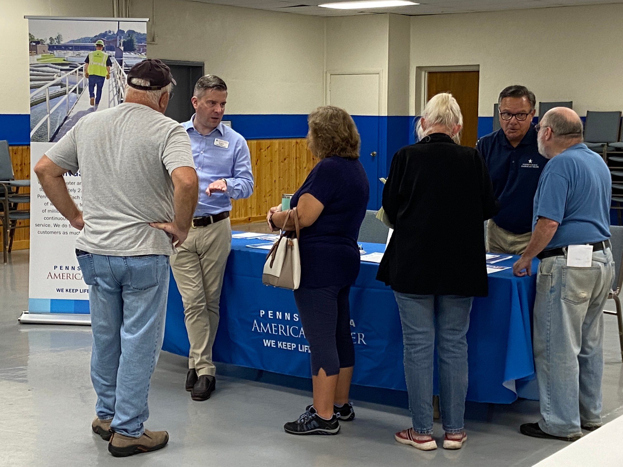 Pennsylvania American executive Ben Morris, in blue shirt, answers questions for East Coventry residents during Wednesday's open house meeting. (Evan Brandt -- MediaNews Group)