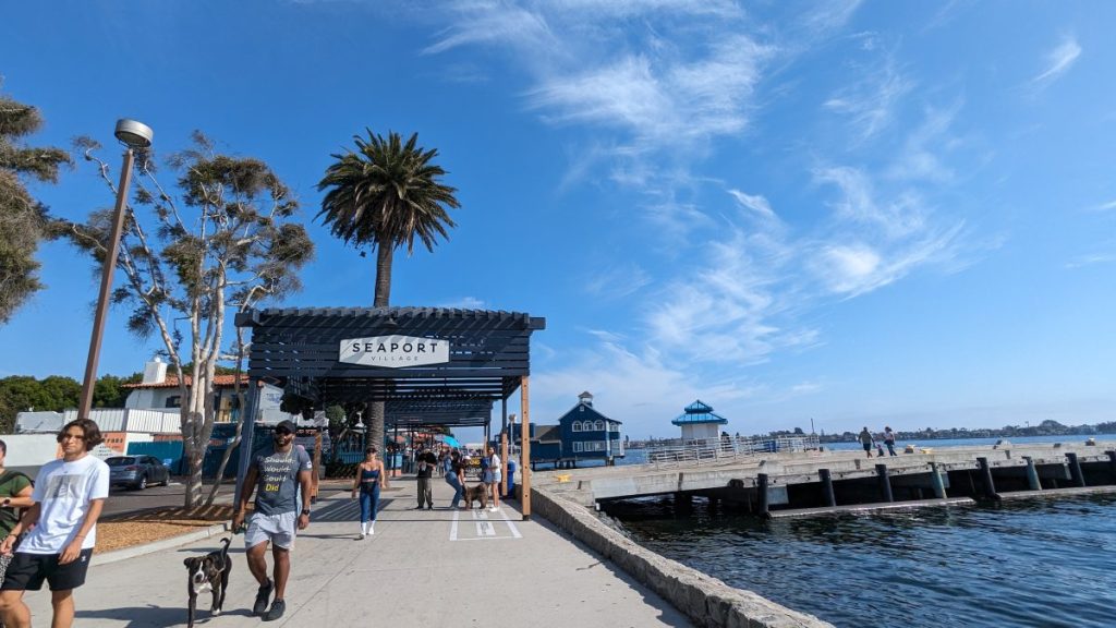 Walkway along the bay in Seaport Village with sign 