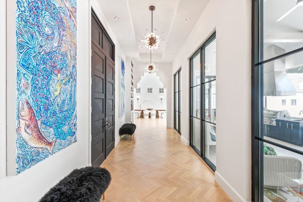 Luxurious and illuminated hallway with abstract light fixtures. 