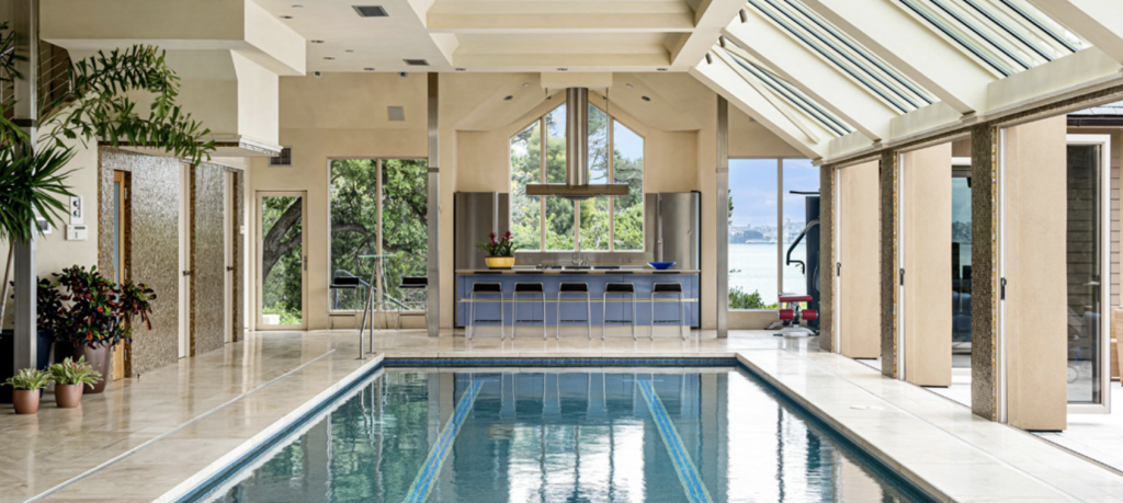 Luxurious indoor pool accompanied by large kitchen area. 