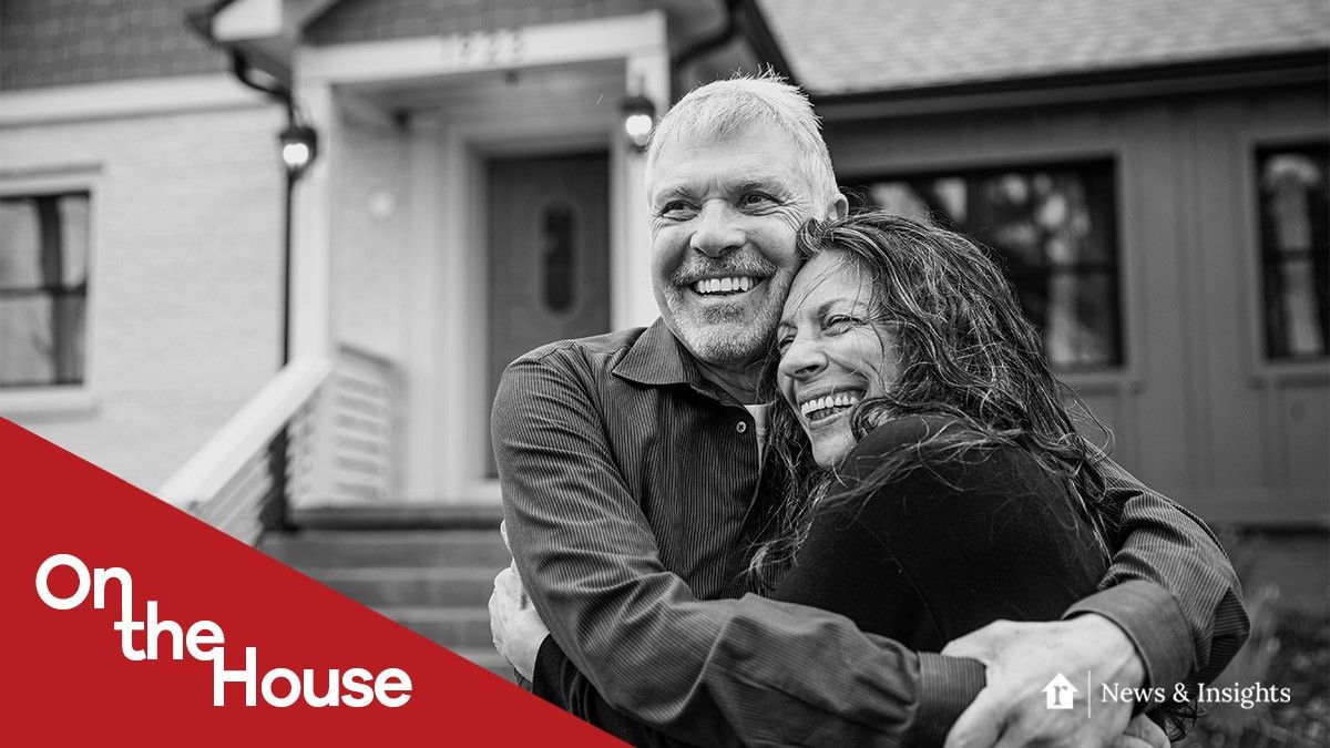 couple in front of their new home