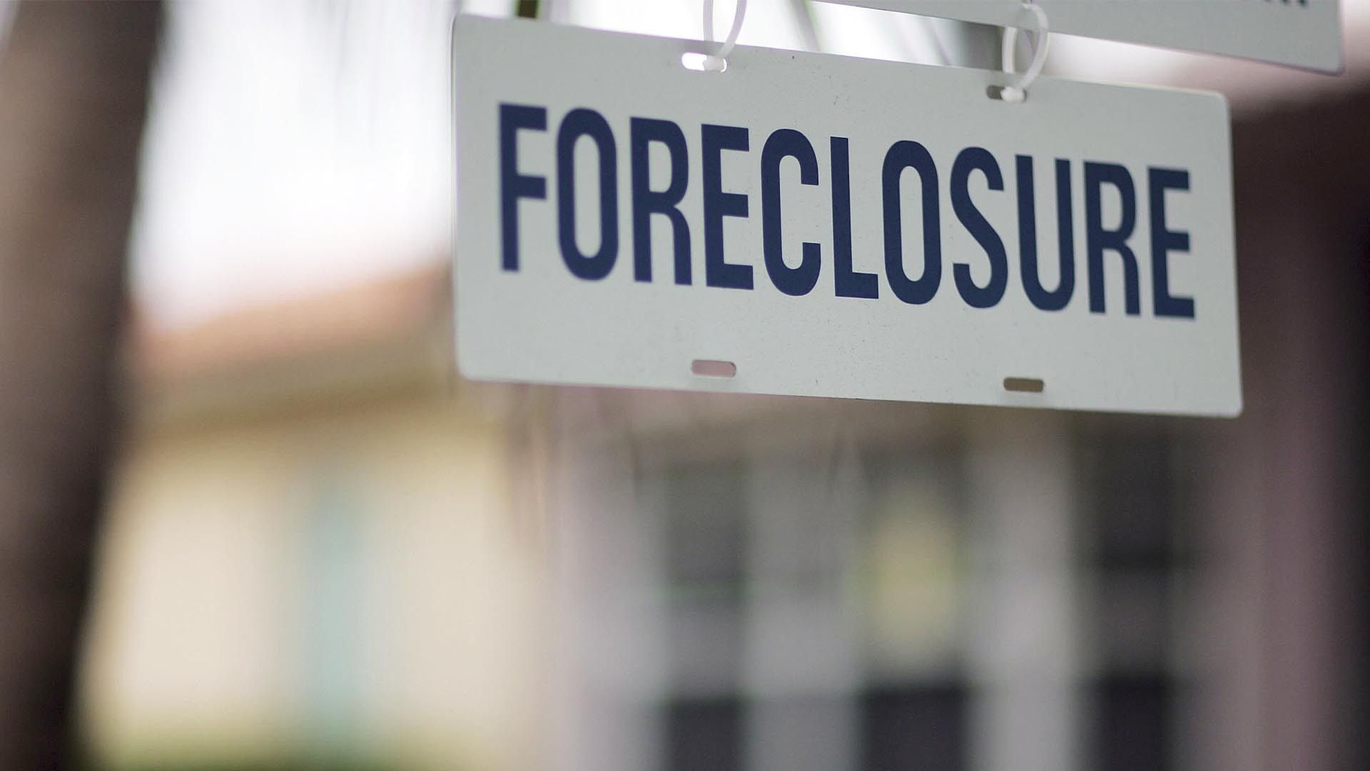 house with foreclosure sign