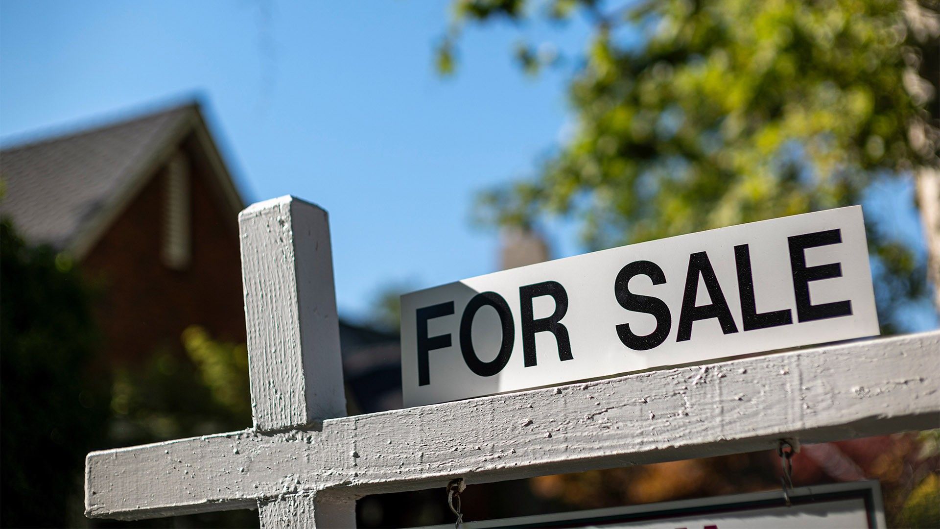 a for sale sign in front of a home