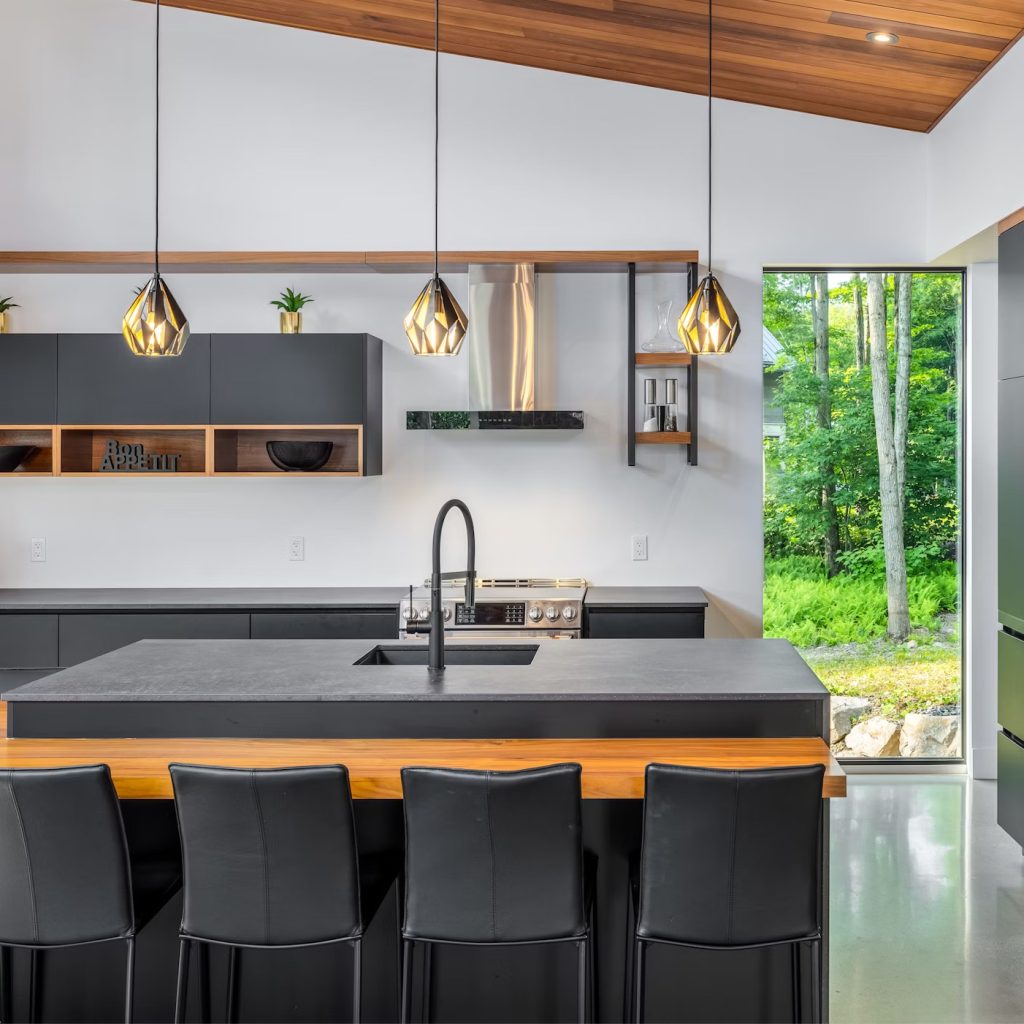 Bold and dark kitchen decor with unique light fixtures. 