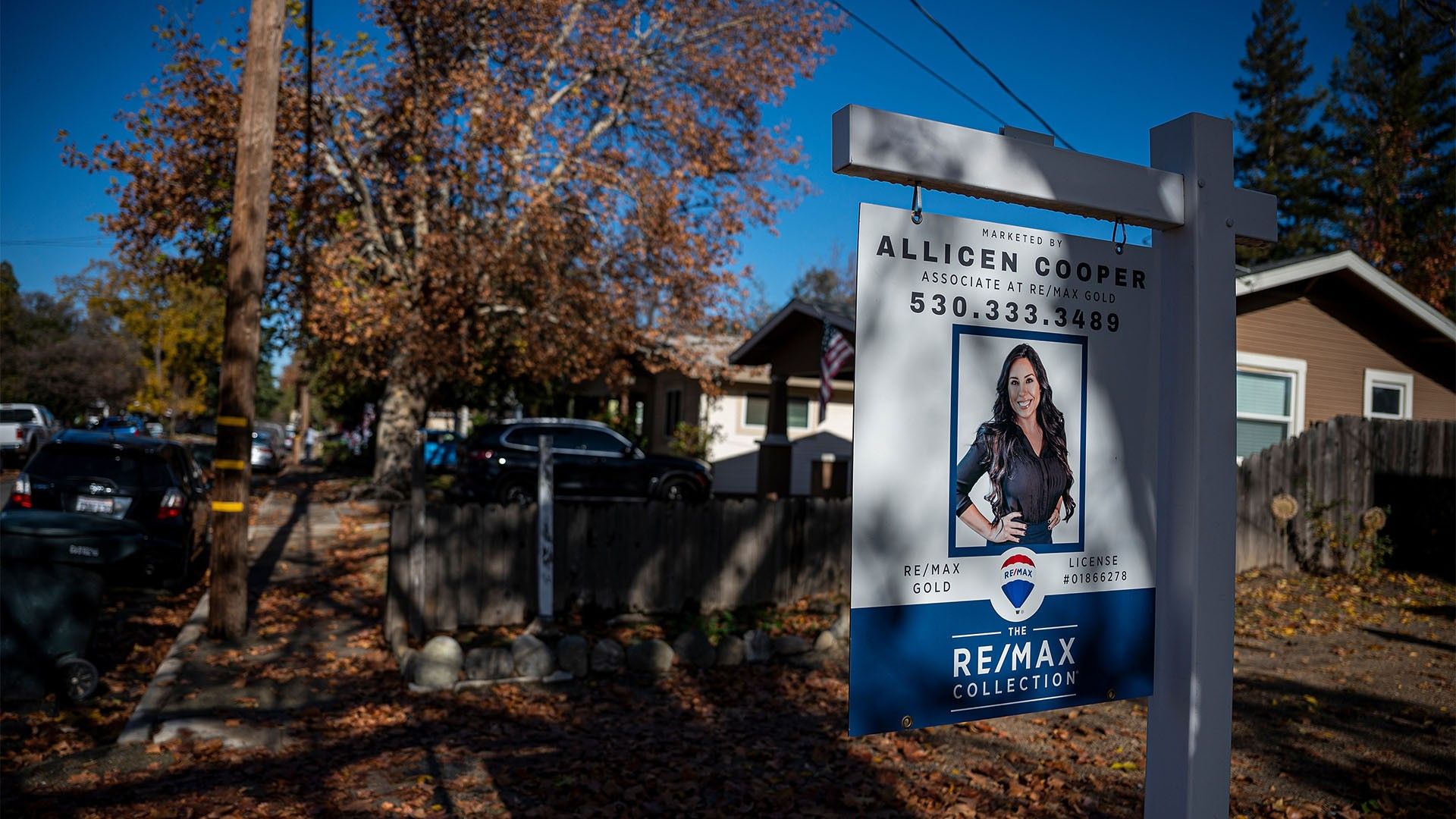 A 'for sale' sign in front of a home during the early autumn season in CA
