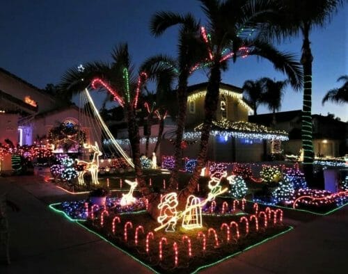 Christmas lights on house and palm trees San Diego: Candy Cane Lane Poway