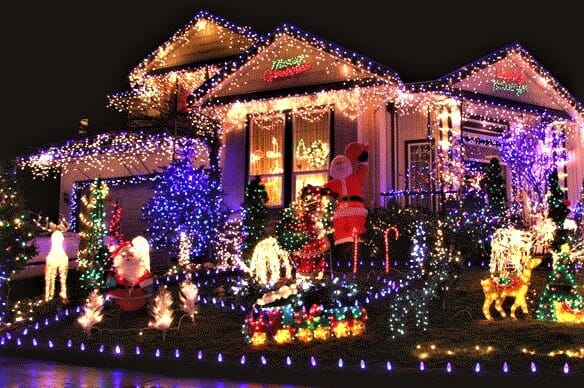 House decorated with many lights and figurines for Christmas