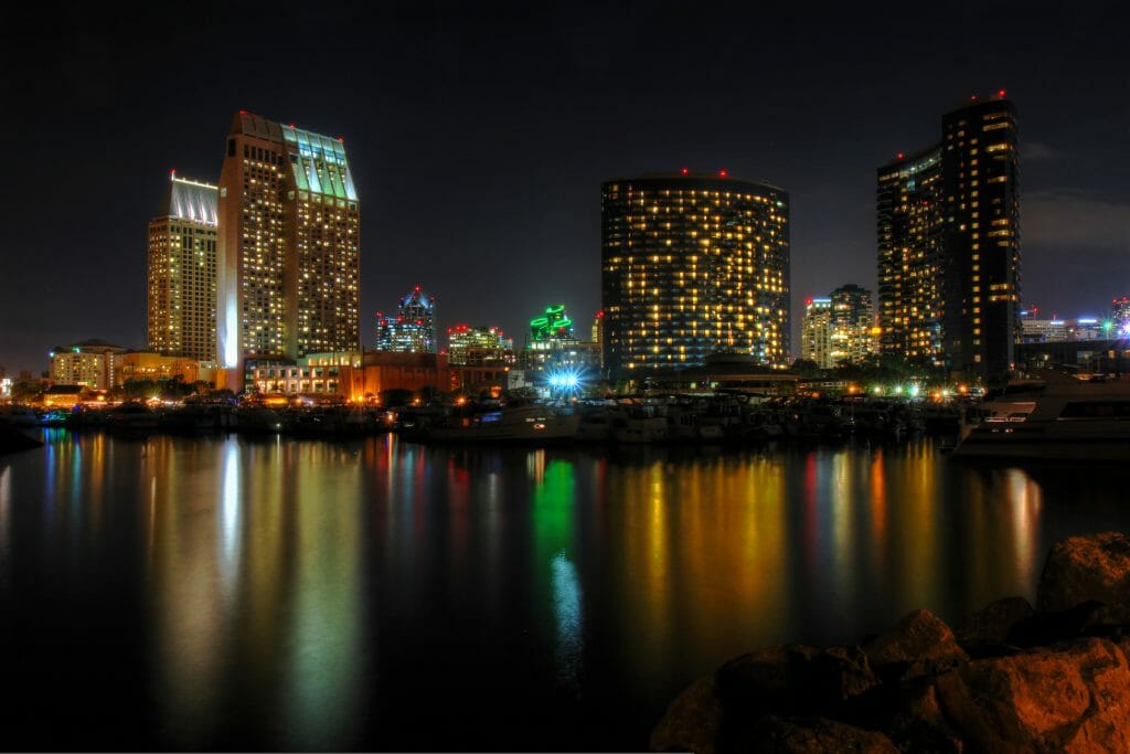 The night lights of the San Diego skyline twinkle and reflects against the water