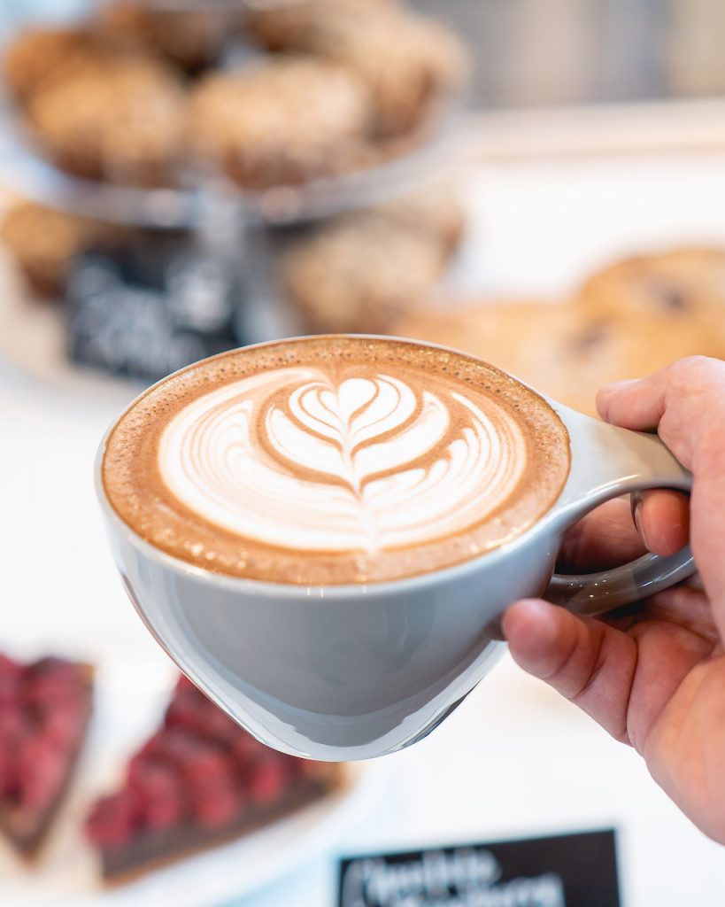 A gorgeous mug filled with coffee and decorated lovingly with milk foam art