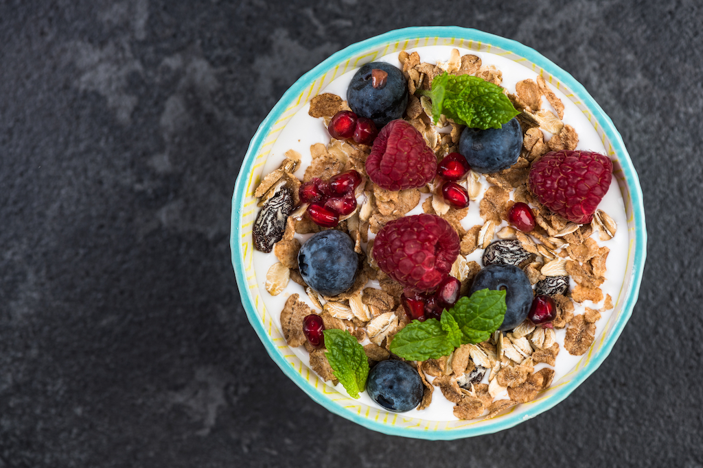 Homemade healthy brunch or breakfast bowl, top view on granite table.