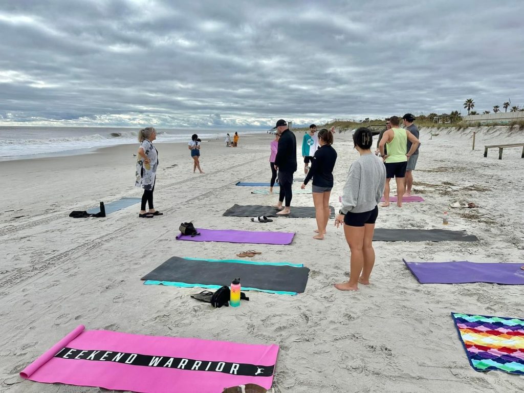 Engel & Völkers First Coat holding a yoga class on the beach to fundraise for Special Olympics.