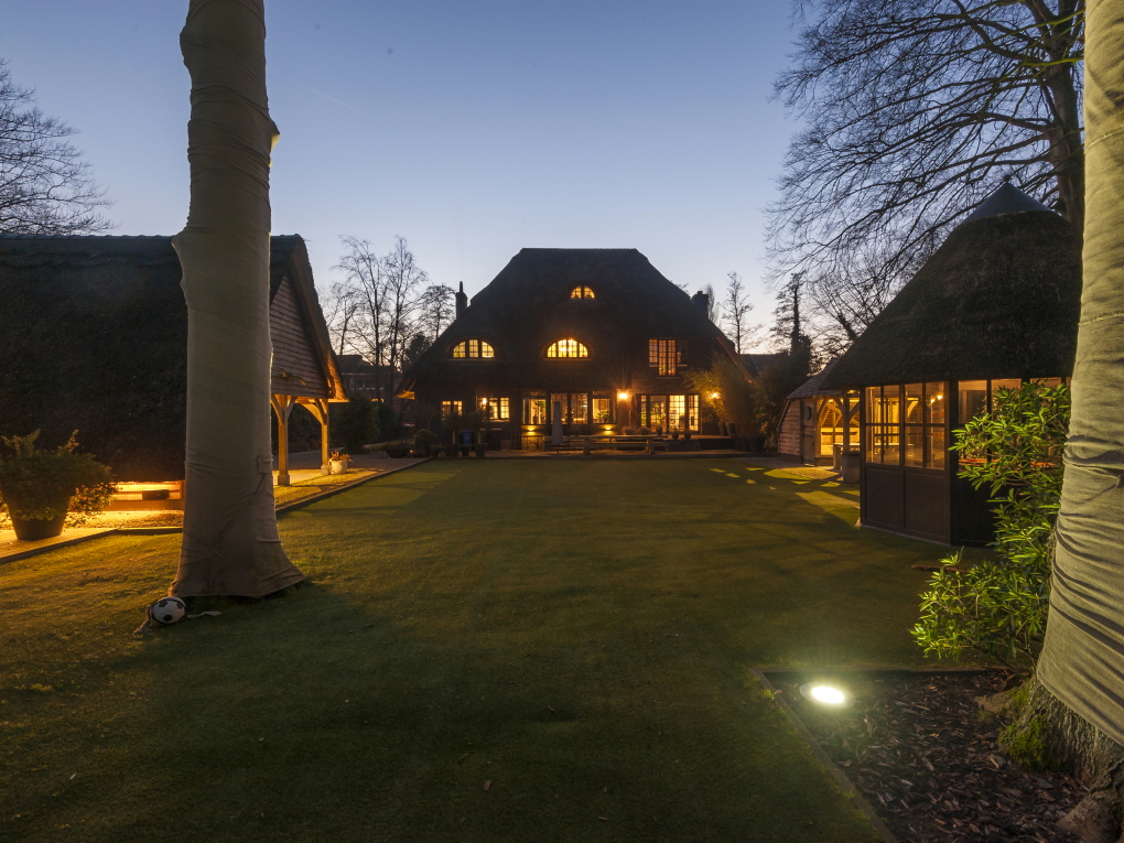 Lit up cottage with large backyard.