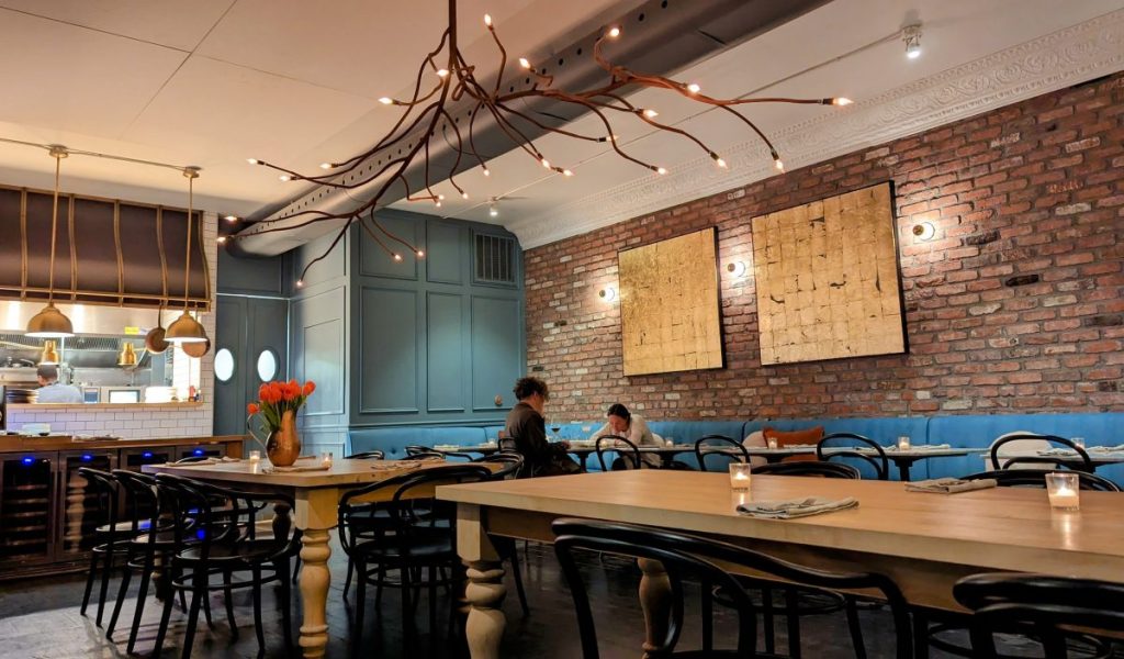 2 big communal tables in the middle of the dining room at black radish restaurant san diego