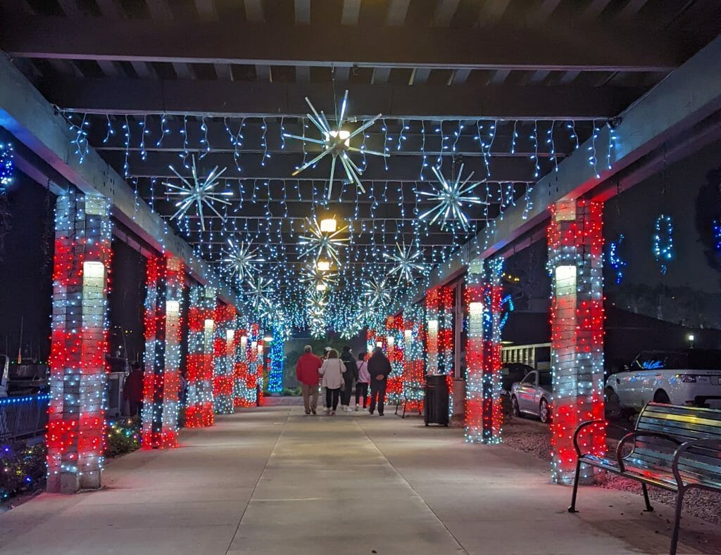 Covered walkway decorated with red and white lights and stars for the Holidays