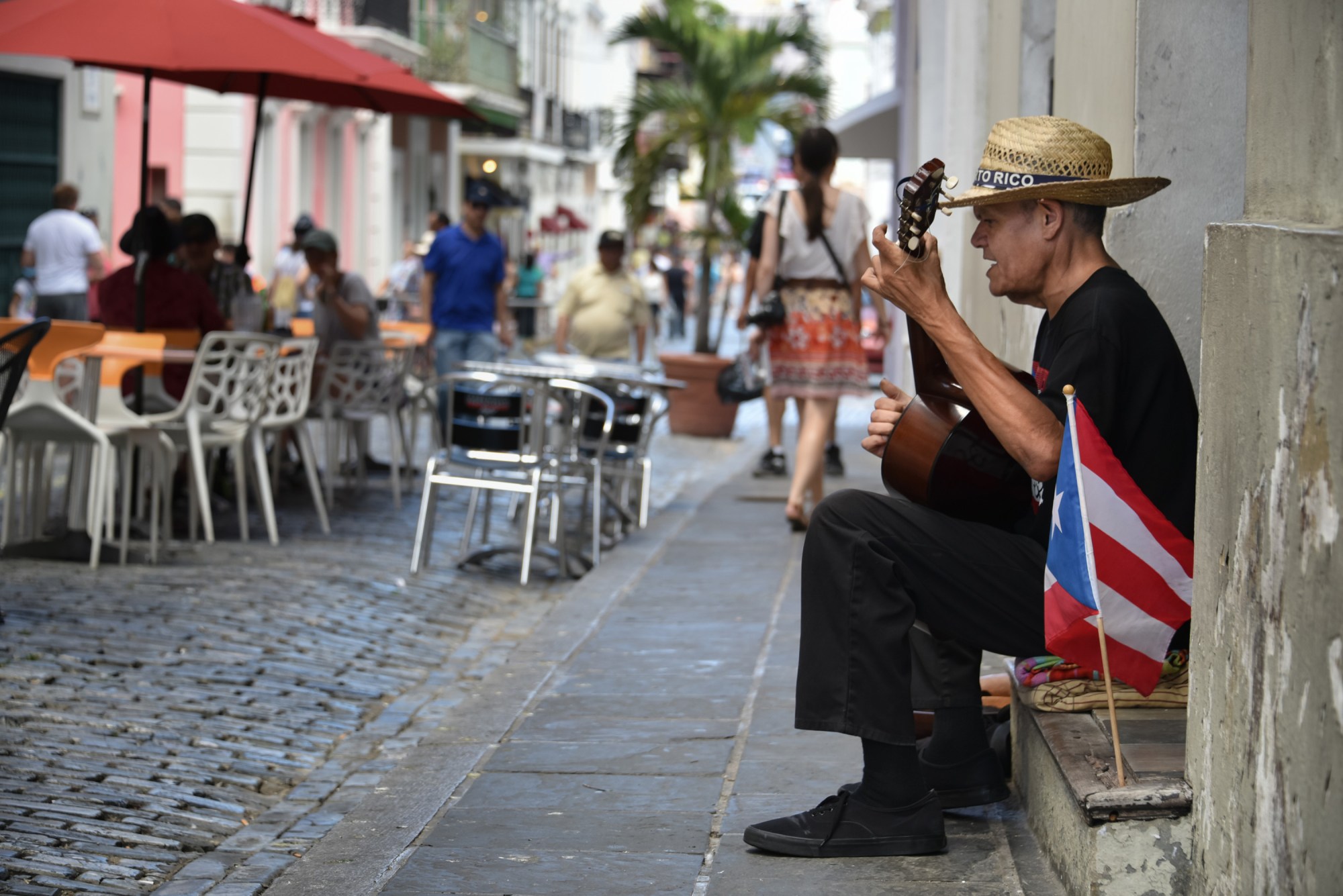 A street performer serenades diners in San Juan, Puerto Rico. Puerto Rico boasts colorful colonial architecture, and free-roaming dogs, horses and chickens lend the island an international feel. (Mihai Coman/Dreamstime/TNS)