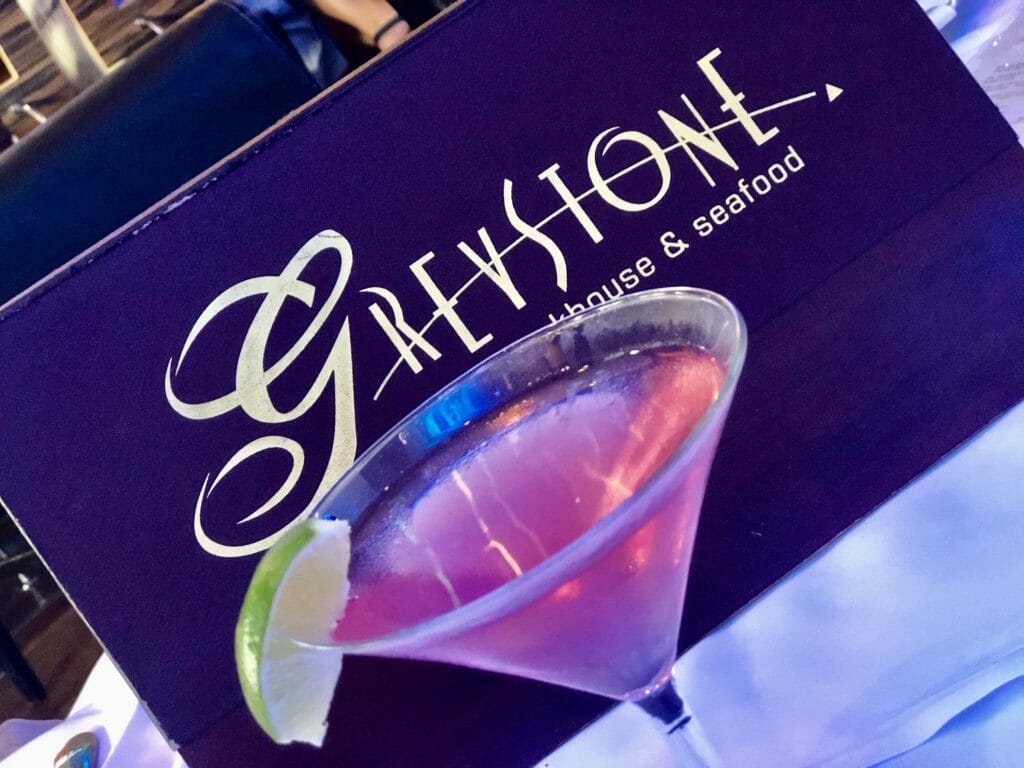 Greystone San Diego menu with pink cocktail in a martini glass in front